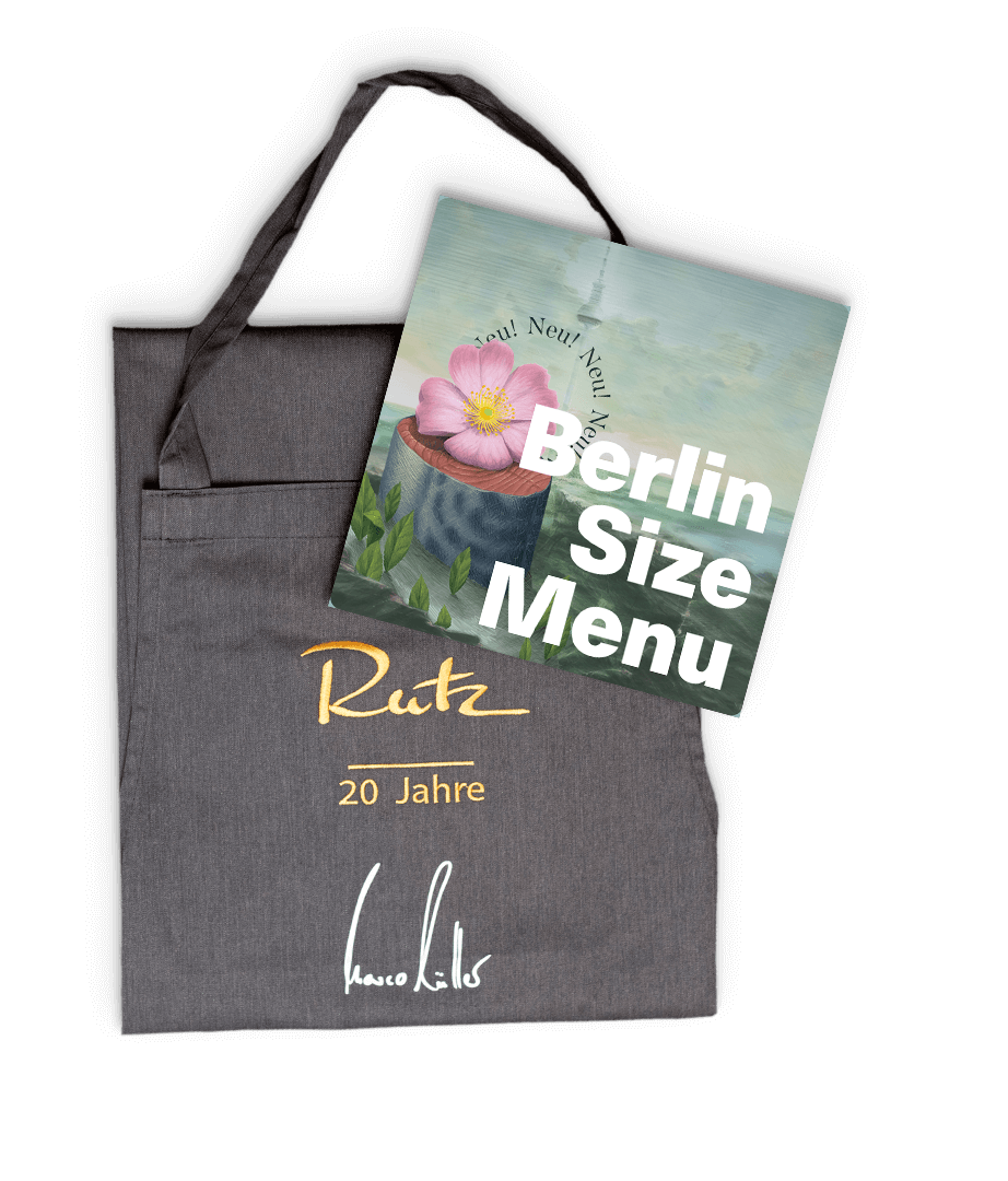 Featured image for “Gutschein für 2x Berlin Size Menu inkl. "20 Jahre Marco Müller"-Schürze”